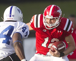 Geoffrey Hauschild|The Vindicator.YSU's Kurt Hess (12) encounters Indiana State's Larry King (44) and dives to the ground to avoid injury while scrambling during the fourth quarter of a game at YSU's Stambaugh Stadium on Saturday afternoon.