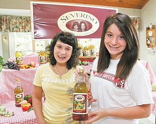 Severino Sisters Italian Dressing is named for Severino’s two daughters, Marissa, 14, left, and Bianca, 19. The Ohio Turnpike worker is selling about six cases per week.
