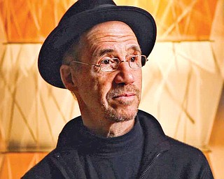 Artist Sydney Cash stands in front of one of his sculptures.