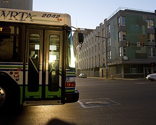 A WRTA bus heads southbound along Market Street through Federal Plaza in downtown Youngstown as the sun rises Friday morning.