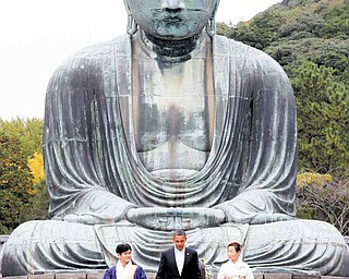 President Barack Obama visits the Great Buddha of Kamakura with Michiko Sato, temple director, and Takao Sato, the 15th chief monk of the temple, at Kotokuin Temple in Kamakura, Japan, Sunday, Nov. 14, 2010. (AP Photo/Charles Dharapak)