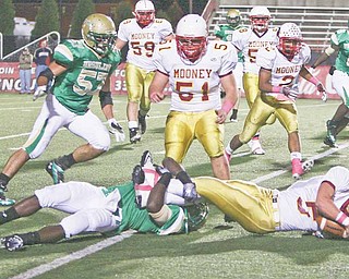 Ursuline High senior Mike Zappa (57) comes into help on a play during the Irish’s victory over Cardinal Mooney this season. Zappa has been a backup player for Ursuline until this season, and is one of the team’s mainstays on the off ensive and defensive lines.