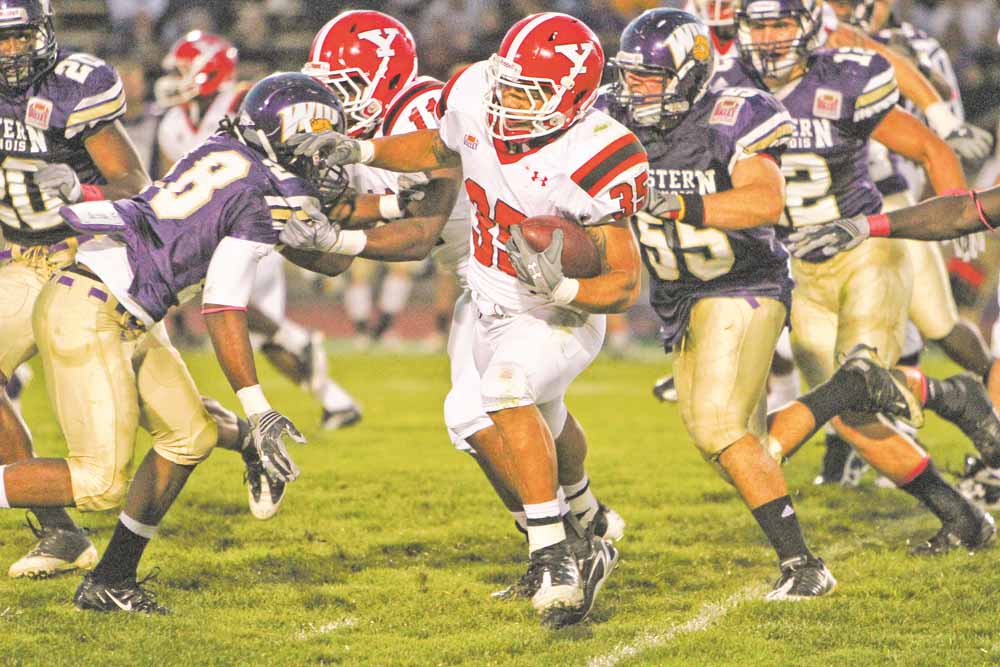 YSU tailback Jamaine Cook tries to avoid the pursuit of WIU linebacker Anthony D'Astice during the first half of the Penguins' game at Western Illinois. Cook had 72 yards on 17 carries in the first half. 
