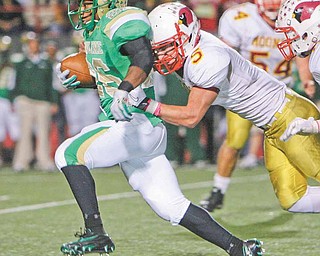 Moving out as #26 Akise Teague caries Mooney #5 Kevin McGuire as he sprints for another first down during second quarter action - Ursuline vs Mooney at YSU stadium.