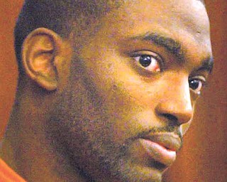 Taran Helms shoots a look and makes a motion before being led from the courtroom.