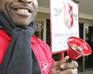 With a smile to go along with his Salvation Army bell, Demetric Brown of Youngstown rings for money in front of the downtown post office on Walnut Street as part of the SA’s Red Kettle Campaign.
