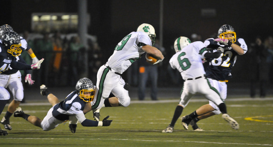 McDonald's Mike Helco make the open field tackle on Mogadore's Jake McAvinew during their Div VI playoff game at Twinsburg on Friday night. Photo/Mark Stahl