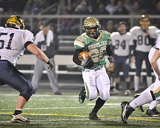 Ursuline's Akise Teague runs the ball against Kirtland during the first half of their game in Auora on Saturday night. Photo/Mark Stahl