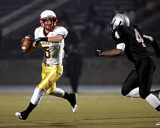 NOVEMBER 20 - RAVENNA-OHIO:  Kevin McGuire #5 of the Cardinal Mooney Cardinals rolls out to pass against the Akron Buchtel Griffs at Ravenna High School on November 20, 2010.  (photo by:  Justin K. Aller)