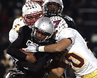 NOVEMBER 20 - RAVENNA-OHIO: Nick Hargate #40 and Austin Trgovcich #59 of the Cardinal Mooney Cardinals make a tackle against the Akron Buchtel Griffs at Ravenna High School on November 20, 2010. (photo by: Justin K. Aller)