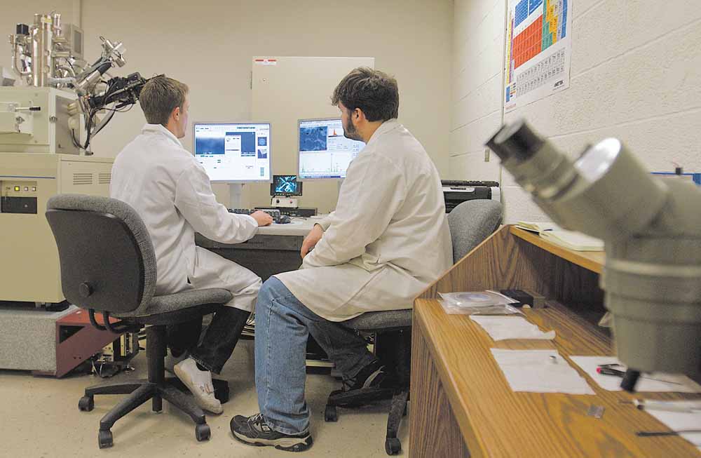 Chemical Engineering Major Anthony Yurcho and Chemistry Masters student, Dominic Loiacona use a scanning electron microscope at YSU's Ward Beecher Hall.