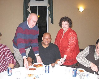 Although he didn’t have to sing for his supper, Brian Keith Johnson enjoyed being served by, from left, James Collier, treasurer of Youngstown Opera Guild, and Carla L. Infante, president of YOG, during a hospitality dinner that preceded a recent performance of “La Traviata” at Stambaugh Auditorium.