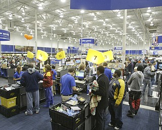 William D. Lewis|The Vindicator A large crowd qued up outside the Boardman Best Buy at 5am Friday to get Black Friday bargins. Customers check out with bargins..