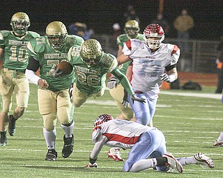 FOOTBALL - Akise Teague flies over Rufus Johnson for yards Saturday night in Ashland. - Special to The Vindicator/Nick Mays