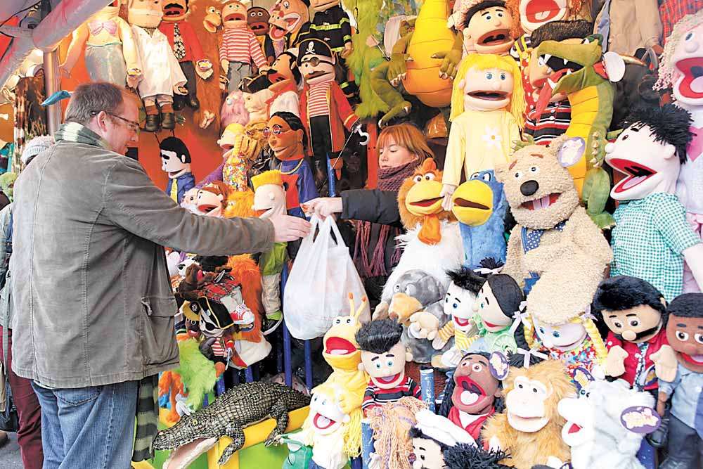 A vendor sells puppets at the Union Square Holiday Market, Sunday, Nov. 28, 2010 in New York.  