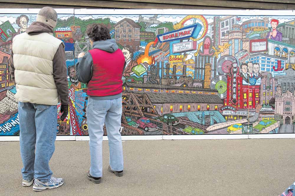 People who attended Mill Creek Park’s Olde Fashioned Christmas at the Mill were treated to a 24-feet-long traveling mural by Bob Barko Jr. It depicts the history of Youngstown from 1796 to 2007.