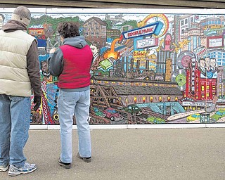 People who attended Mill Creek Park’s Olde Fashioned Christmas at the Mill were treated to a 24-feet-long traveling mural by Bob Barko Jr. It depicts the history of Youngstown from 1796 to 2007.