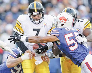 Pittsburgh Steelers' Ben Roethlisberger (7) is pressured by Buffalo Bills' Aaron Maybin (58) and Chris Kelsay (90) during the second half of an NFL football game in Orchard Park, N.Y., Sunday, Nov. 28, 2010. The Steelers won 19-16 in overtime.