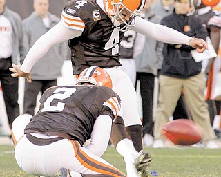 Cleveland Browns placekicker Phil Dawson (4) boots a 41-yard field goal out of the hold of punter Reggie Hodges (2) late in the fourth quarter during their NFL football game against the Carolina Panthers on Sunday, Nov. 28, 2010, in Cleveland.  The kick proved to be the game-winner in the Browns' 24-23 win. 