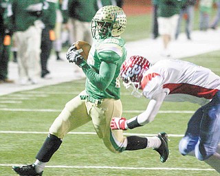 Ursuline's Akise Teague flies past Lima's Rufus Johnson Saturday night in Ashland. 