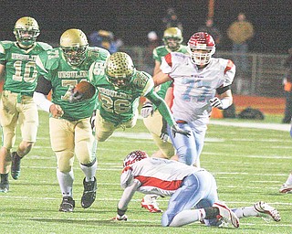 Ursuline's Akise Teague flies over Lima's Rufus Johnson for yards Saturday night in Ashland.