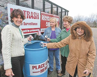 Autumn weather may call for sweaters and coats but plans for spring planting are on the minds Liberty in Bloom supporters. They promote recycling as a way to fund the planting project. From left are Liberty Township Trustee Jodi Stoyak, Carol Cupan, Janet Yaniglos and Bessie Anderson.  