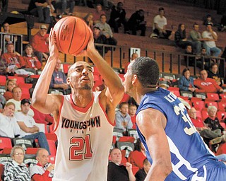 YSU's Damian Eargle lines up a shot while being guarded by Buffalo's Jawaan Alston (32) during a game at YSU's Beeghley Center on November 16, 2010.