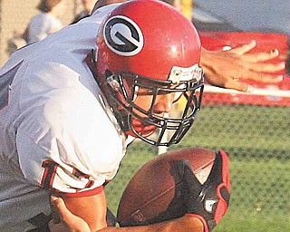 Eric Ahmer makes a one handed tackle of Landon Smith Friday night in Struthers.
