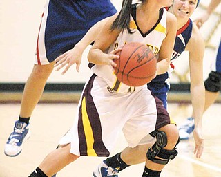 BASKETBALL - (10) Kenzie Pfeiffer of South Range looks for help as (10) Colleen Kenneham keeps a close eye on her during their game Thursday night. - Special to The Vindicator/Nick Mays