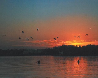 These fisherman were likely unaware that Lana VanAuker of Canfield captured them in this shot of a fall sunset in Lake Milton.