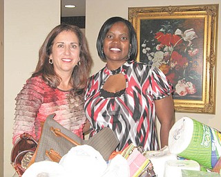 A good deed is done: Sperry Rongone, left, a Boardman-Poland Junior Women’s League provisional member, and Audrey Walker from the Sojourner House stand with some of the items collected for Sojourner. The house shelters women and children who are victims of domestic violence. Rongone’s provisional project was to collect items from members of the BPJWL that were included on a wish list from residents. She will be installed as a new member at the December social.