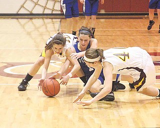 (22) Lexi Naples and (40) Elli Stoffer of South Range try to keep (12) Alyssa Shields from the ball during their game Monday night.