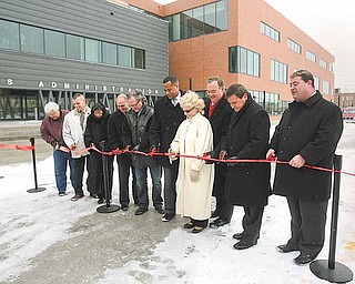 From left, dignitaries cutting the ribbon Monday to open the northward Hazel Street extension connecting Youngstown’s downtown to Youngstown State University outside the university’s Williamson College of Business are: Councilman John R. Swierz, D-7th; Jason Riffle, president of United Civil Contractors and Developers Inc. of Hubbard, which built the street; Councilwoman Annie Gillam, D-1st; State Sen. Joe Schiavoni, D-33rd, of Canfield; State Rep. F. Hagan, D-60th, of Youngstown; Mayor Jay Williams; Cynthia Anderson, YSU president; State Rep. Ronald V. Gerberry, D-59th, of Austintown; David Mosure, vice president of MS Consultants of Youngstown, project engineers; and Charles Shasho, the city’s deputy director of public works.