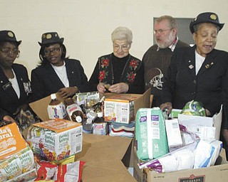William D. Lewis | The Vindicator/Giving a helping hand to vets: Auxiliary members of American Legion Post 504, 2225 Glenwood Ave., Youngstown, recently gathered items to be donated to needy veterans in the area. On hand Dec. 2 at the post home when the donation was made were, from left, auxiliary members Yolanda Charles, Rose Jordan and Shirley Griffin; Faye Humbertson, American Legion Auxiliary representative at the Youngstown Veterans Affairs Outpatient Clinic on Belmont Avenue in Youngstown; Robie Rhoads, a veteran staying at the Meridian Services home for veterans in Youngstown; and auxiliary members Lillie Langford and Betty Dukes.