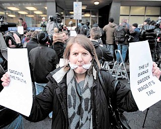 A supporter of Wikileaks founder Julian Assange, poses for members of the media outside the City of Westminster Magistrates Court in London where Julian Assange's case was heard, Tuesday, Dec. 7, 2010. Julian Assange was jailed Tuesday after the WikiLeaks founder told a London court he would fight efforts to extradite him to Sweden, where he faces a sex-crimes investigation.