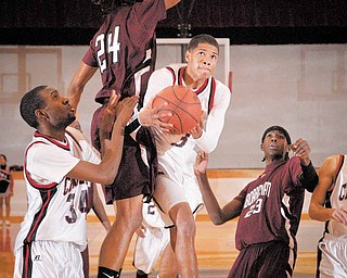 Campbell's Claxton LeBron takes the ball to the basket against Boardman's Dane Hammond, 24, durig their game a Campbell on Tuesday Night.