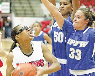 YSU's Kenya Middlebrooks is hemmed in by IPFW's #50 Sydney Weinert  and #33 Jordan Zuppe  during first half action Saturday, Dec. 4, 2010, at YSU.
