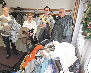 Promoters of the Warm and Cuddly Drive at First Free Will Baptist Church in Austintown hold coats donated to the project. From left are: Harold Davis, deacon; Mary Hutchison, coordinator; Aaron Justice, youth minister; and Jack Hutchison, board member.