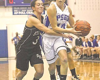 10) Emily Rollo of Poland drives to the hoop as (3) Adrianna Garchar plays tight defense during their game Thursday night.