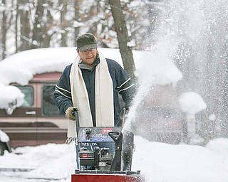 Jimmie Digiacobbe of state Route 5 in Cortland uses his snow blower to clear his property Thursday. The Mahoning Valley has recorded a near-record level of snowfall this December and certainly will set a new monthly record over the next three weeks.