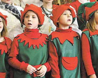 Singing elves, from left, Alexia Stoy, Owen Banko, James Jones and Samantha Misik performed Thursday in a production called “Holidays Around the World.” This is the third year Lloyd Elementary School in Austintown has presented the production.