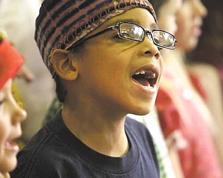 Justus Jones sings a Christmas carol during the production. Justus is a student in Amy Bungard’s class and dressed as someone celebrating Christmas in South Africa.