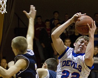 Western Reserve's Thomas Benyo (22) comes away with the rebound during a game at Western Reserve High School on Friday evening.