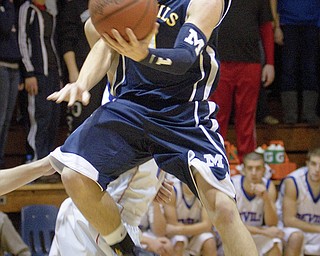 McDonald's Justin Rota (1) drives to the net during a game at Western Reserve High School on Friday evening.