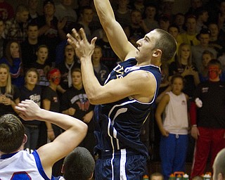 McDonald's Matthias Tayala (24) drives to the net during a game at Western Reserve High School on Friday evening.