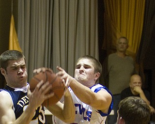 McDonald's Nick Rota (23) wrestles for control of the ball with Western Reserve's Thomas Marlowe (11) during a game at Western Reserve High School on Friday evening.