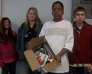 The freshmen at Struthers High School participated in The Vindicator's Operation Holiday Cheer project recently. The students put together 17 packages and wrote 180 letters to send to area soldiers. Among those involved in the project were, from left, Marissa Fusco, Marissa Stone, Don Barnes and Travis Gartlic.