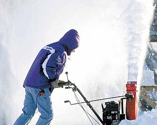 Kevin Eastvold of Mason City, Iowa, pushes through the snow at the end of his driveway with a snowblower on Sunday, Dec. 12, 2010. Winter storms passed over North Iowa over the weekend, dumping several inches of snow over the region and causing numerous accidents.