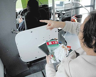 Barbara Altman, 56, points the bus driver in the right direction.