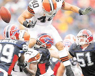 Cleveland Browns running back Peyton Hillis (40) fumbles the ball as he is hit by Buffalo Bills defender Jairus Byrd (31) during the first half of an NFL football game in Orchard Park, N.Y., Sunday, Dec. 12, 2010. Bills linebacker Paul Posluszny (51) assists on the play. 